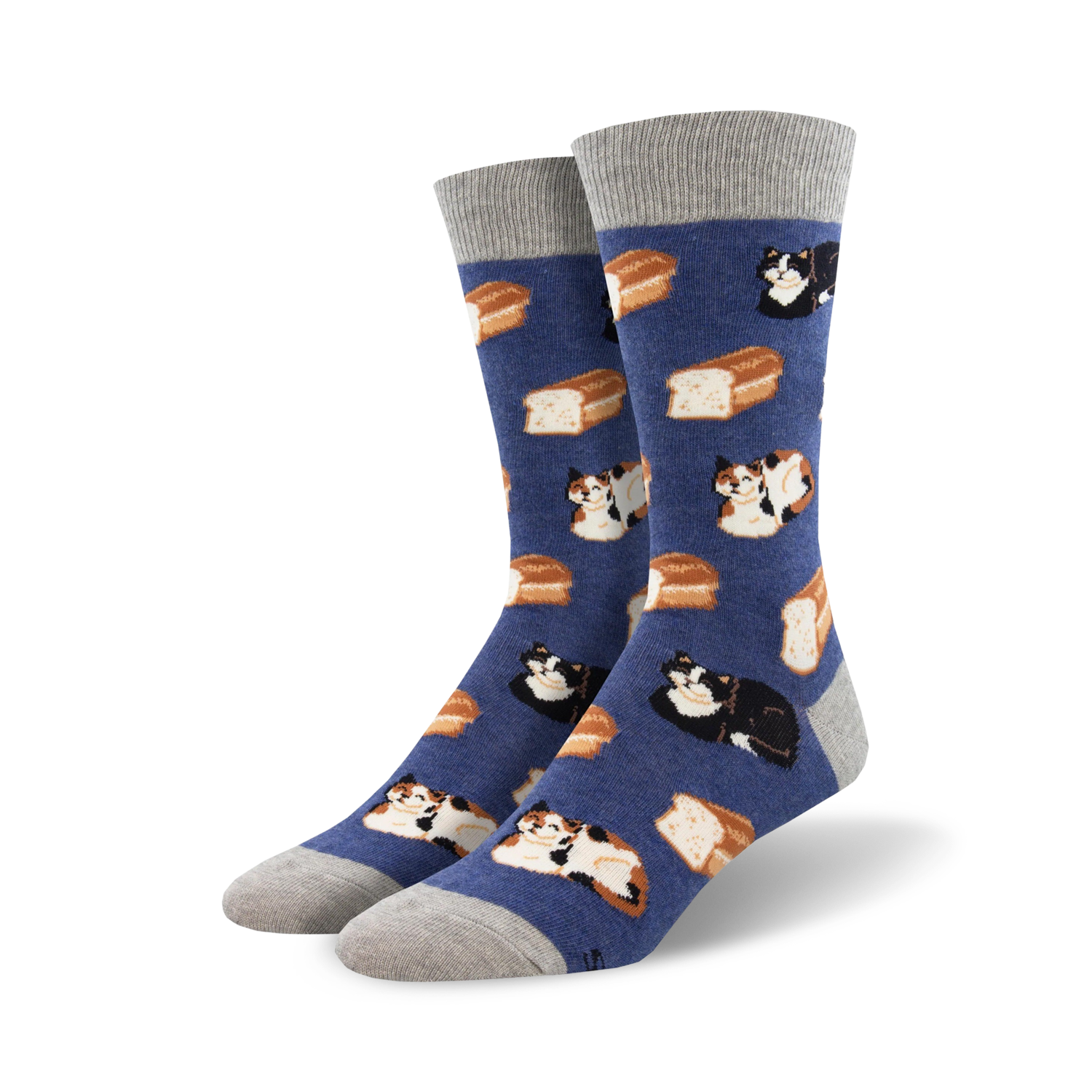 A pair of crew socks in blue with a pattern of cats and bread loaves. The cats are calico and black. The socks have gray cuffs.