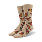 Pair of tan crew socks with a repeating pattern of orange and black monarch butterflies.