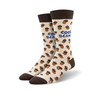 A pair of cream crew socks with brown bean characters wearing sunglasses. The socks have a 'Cool Beans' text and brown cuffs.