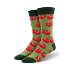 Pair of crew socks with a repeating pattern of red tomatoes on a green background.  Dark green cuffs.