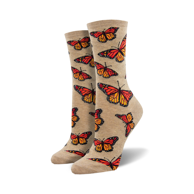Pair of women's crew socks.  Beige and orange monarch butterflies are printed on a light beige background. Fun and colorful.