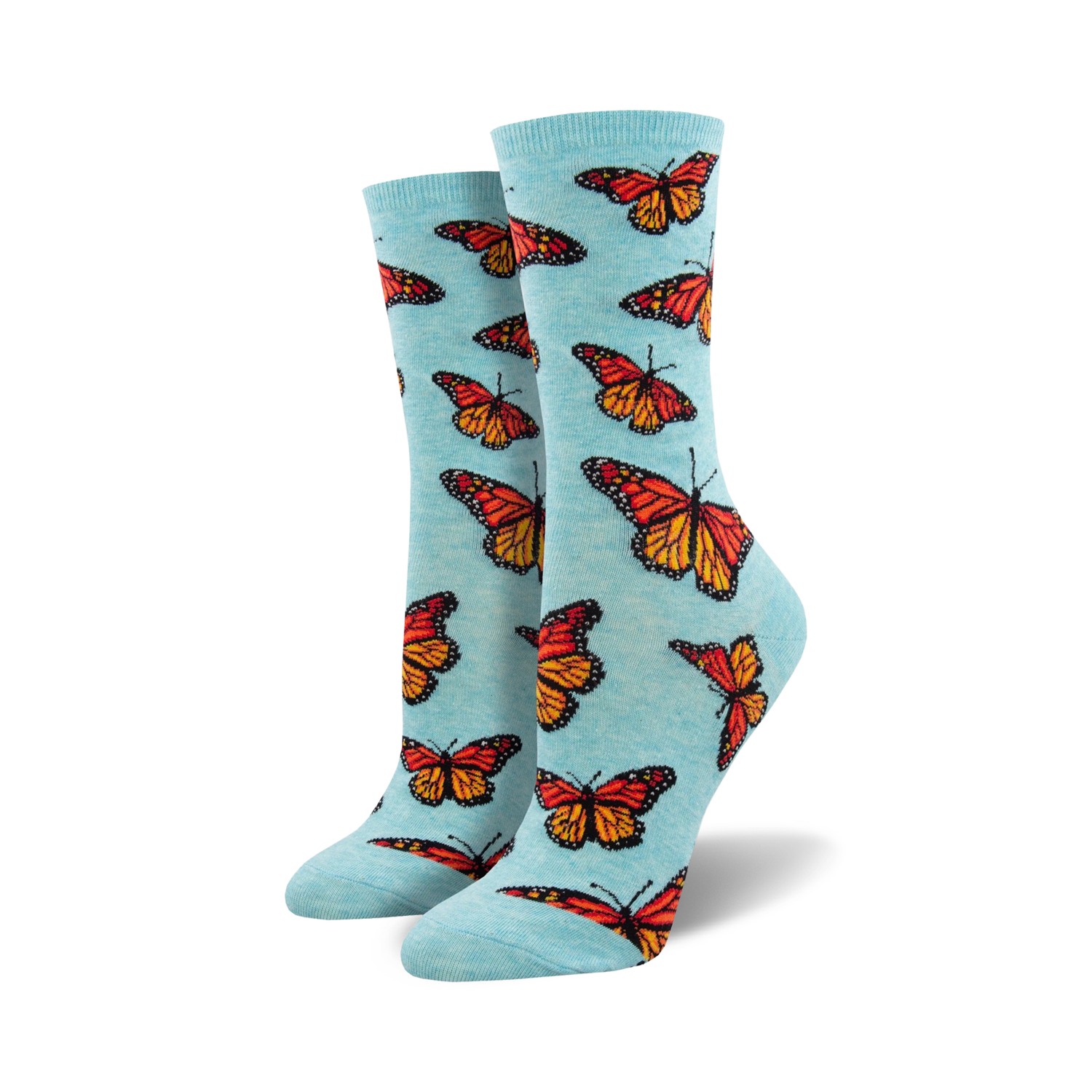 Lifestyle shot: A woman's foot wearing a light blue Social Butterfly sock. The sock showcases the bright orange and red monarch butterfly design.