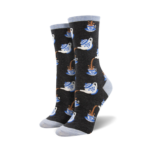 women's crew socks with repeating cartoon teapots in blue and white with brown tea spilling out onto a dark gray background.  