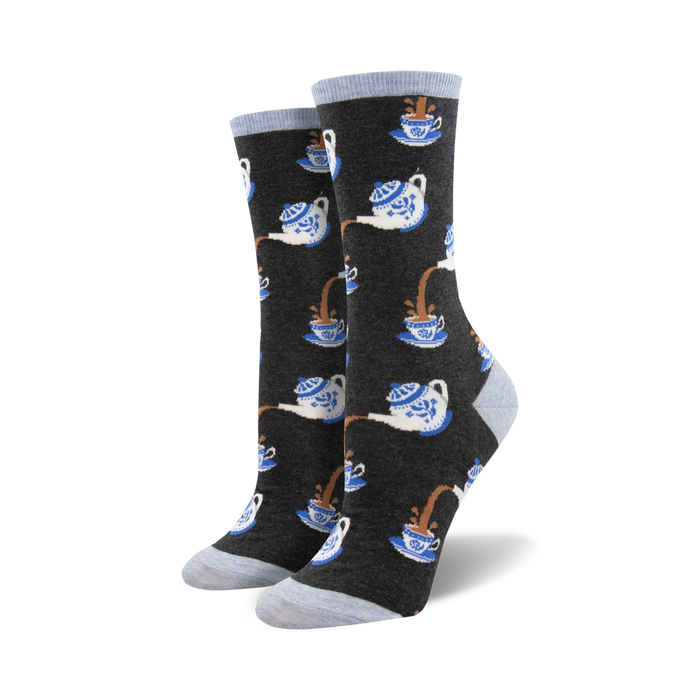 women's crew socks with repeating cartoon teapots in blue and white with brown tea spilling out onto a dark gray background.  