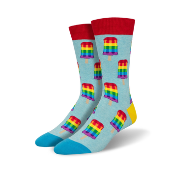colorful popsicle patterned socks in red, orange, yellow, green, blue, and purple on blue background. red sock tops and blue toe and heels. part of the pride collection.  