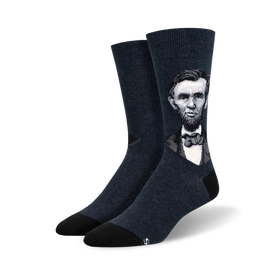 dark blue crew socks feature a pattern of president lincoln's face.   