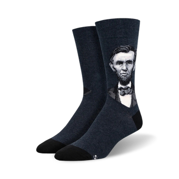 dark blue crew socks feature a pattern of president lincoln's face.   