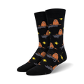A pair of black crew socks with a repeating pattern of brown groundhogs emerging from holes, accented with yellow suns.