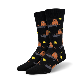 A pair of black crew socks with a repeating pattern of brown groundhogs emerging from holes, accented with yellow suns.