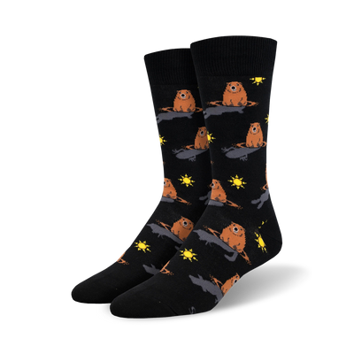 black crew socks featuring a pattern of brown groundhogs popping out of black holes in the ground with yellow suns.  