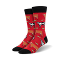 Pair of crew socks; red and black with repeating pattern of brown and black cows in a grassy field.