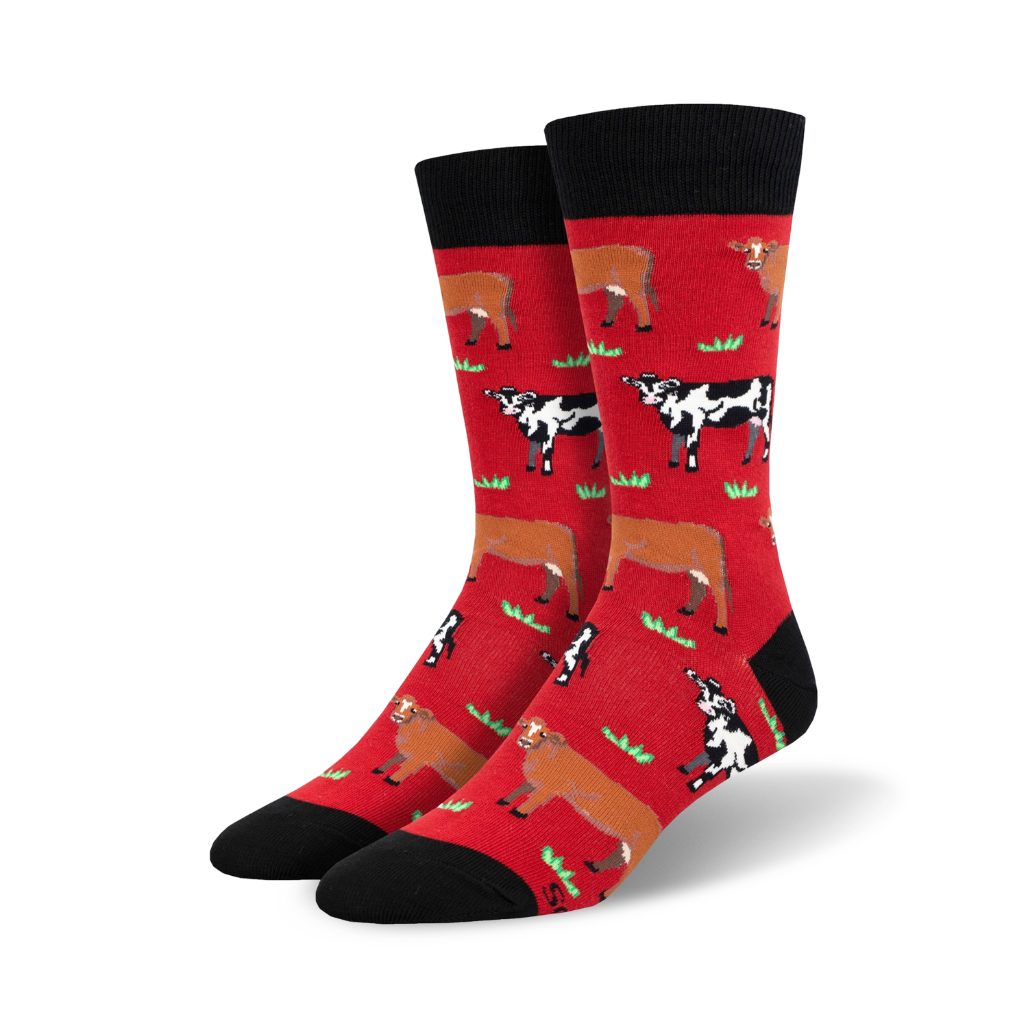 Pair of crew socks; red and black with repeating pattern of brown and black cows in a grassy field.