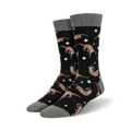 Pair of black crew socks with a pattern of tan otters wearing astronaut helmets and floating amongst white stars.