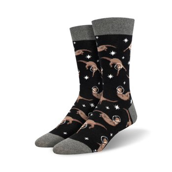 black crew socks adorned with an adorable pattern of cartoon otters wearing space helmets against a starry background.   