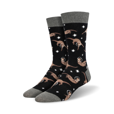 black crew socks adorned with an adorable pattern of cartoon otters wearing space helmets against a starry background.   