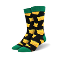 Pair of crew socks with a black background and a repeating pattern of yellow cat-shaped tacos. Green cuffs.