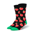 A pair of crew socks with a black background and a repeating pattern of red apples with green stems. The socks have a bright green cuff.