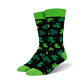 A pair of black crew socks with green shamrocks and lime green cuffs. The socks have a fun, playful design perfect for St. Patrick's Day.