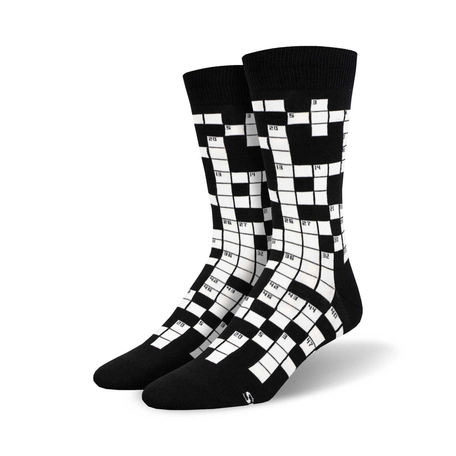 Pair of black and white crew socks featuring a crossword puzzle design. Numbers are visible in the grid.