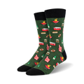 Lifestyle shot showing the green 'Tailgaters Delight' socks on a person's feet; the socks are styled with casual pants.