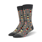 Pair of crew socks in gray and black, featuring a repeating pattern of hot sauce bottles, chili peppers, and skull graphics.