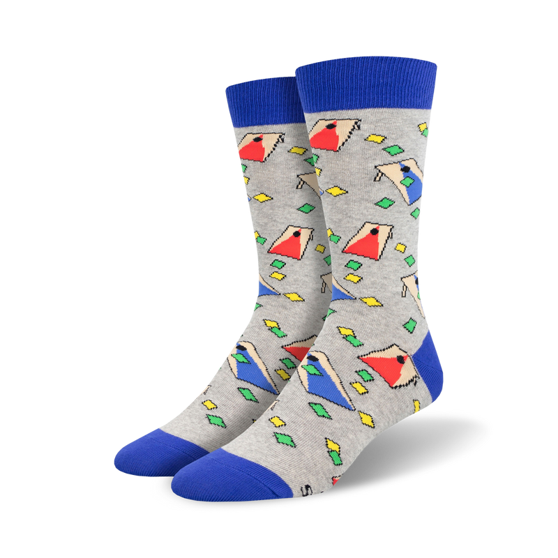 Pair of crew socks in gray with a blue cuff.  The socks feature a repeating pattern of colorful, geometric cornhole board designs.