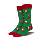 Pair of crew socks; green background, brown poop emojis wearing Santa hats; red cuffs.