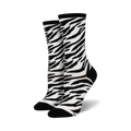 Pair of women's crew socks in a black and white zebra print. The socks have black heels and toes.