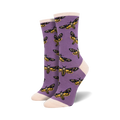 Pair of women's crew socks. Purple socks showcase a repeating pattern of yellow and black skull moths.  Off-white cuffs.