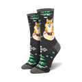 Pair of crew socks; dark gray background with orange foxes, green trees, light blue paw prints, and geometric patterns.