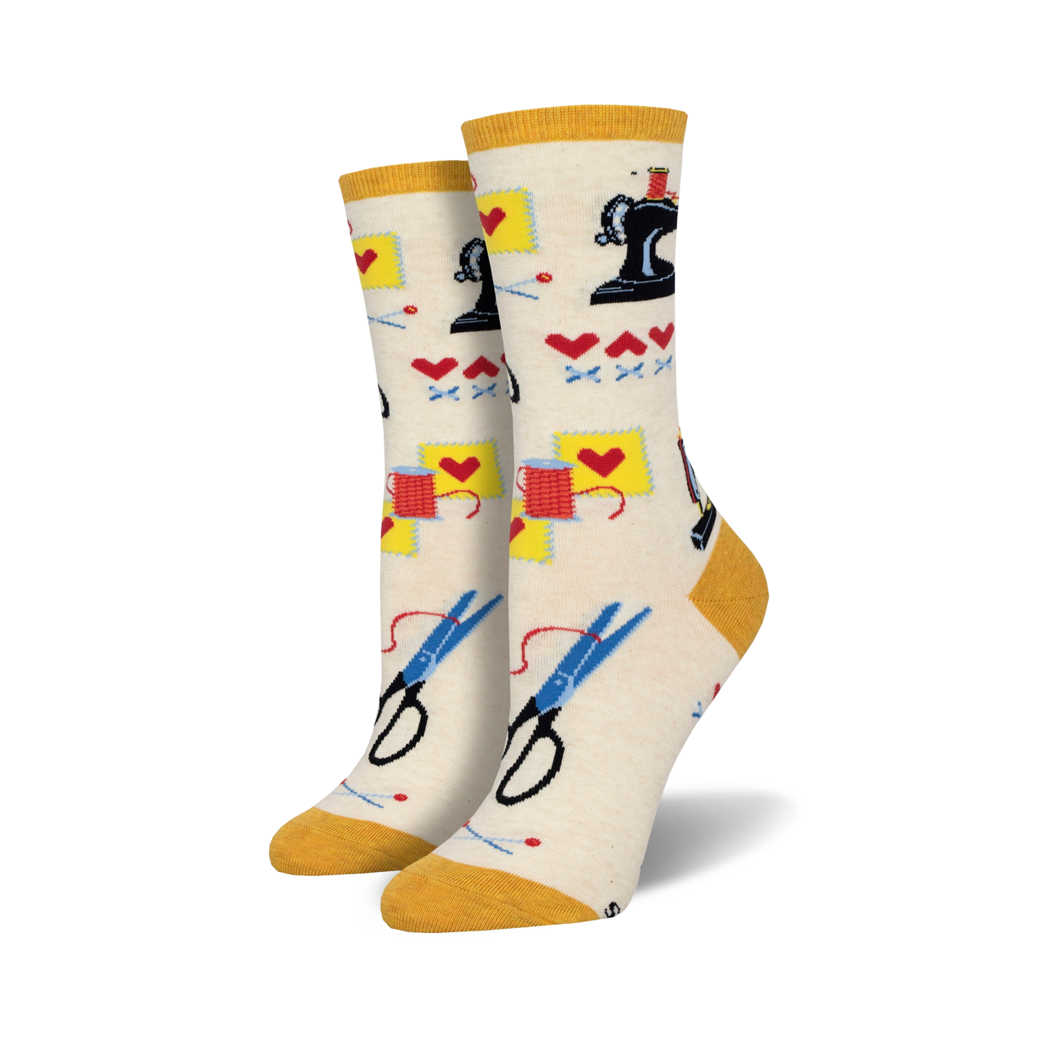 Cream crew socks with a sewing-themed pattern: sewing machines, scissors, thread, and hearts. Yellow cuff.
