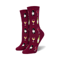 Pair of women's crew socks. Burgundy background with repeating pattern of wine bottles and glasses. 