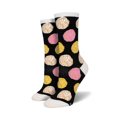 black crew socks with a vibrant pink, yellow, and white concha shell design.   