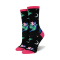A pair of women's crew socks on a white background. Black background with pink fairies riding green hummingbirds, crescent moon, and stars.
