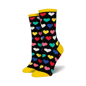 women's crew socks with black background, multi-colored heart pattern, yellow toe and heel, and a black cuff.  