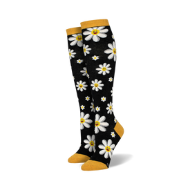 black knee-high socks with white cartoon daisies, yellow centers, and smiley faces. yellow cuffs and heels. womens.   