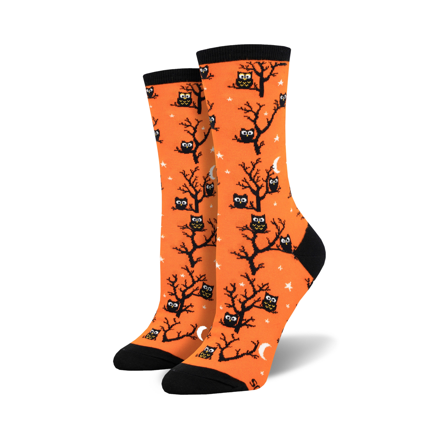A pair of women's crew socks in bright orange. The socks are covered in a pattern of black owls sitting in bare trees against a background of small white stars and crescent moons.