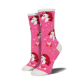 Crew socks in pink featuring red-haired unicorns, candy canes, and presents on a pink background. A festive and fun design!