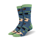 Pair of crew socks in blue with a gardening theme.  Features hands planting seeds, gardening tools, and snails on a soft blue background. Green accents on cuffs.
