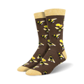 Pair of brown crew socks with a repeating pattern of yellow and black bumblebees and honeycombs.  The socks have a light yellow cuff.