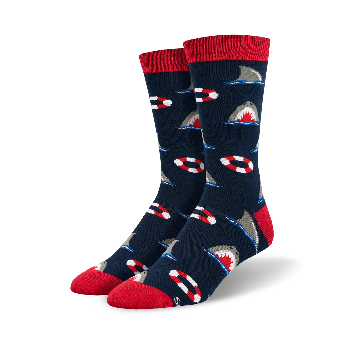 Pair of crew socks in navy blue with a repeating pattern of gray sharks and red and white life preservers. Red ribbed cuff.