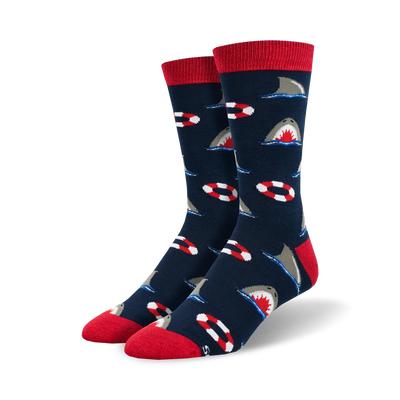 bright blue socks depict great white shark swimming around red and white lifepreservers   