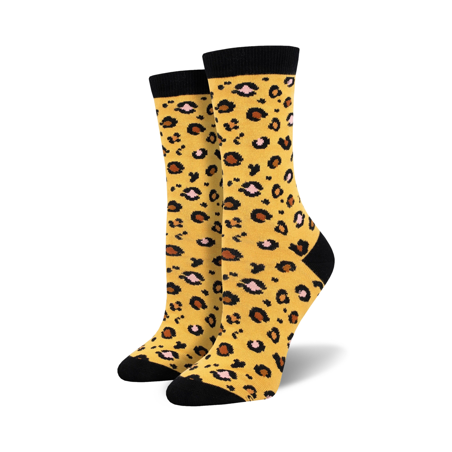 Lifestyle product shot of the yellow leopard print bamboo socks on a model's feet.