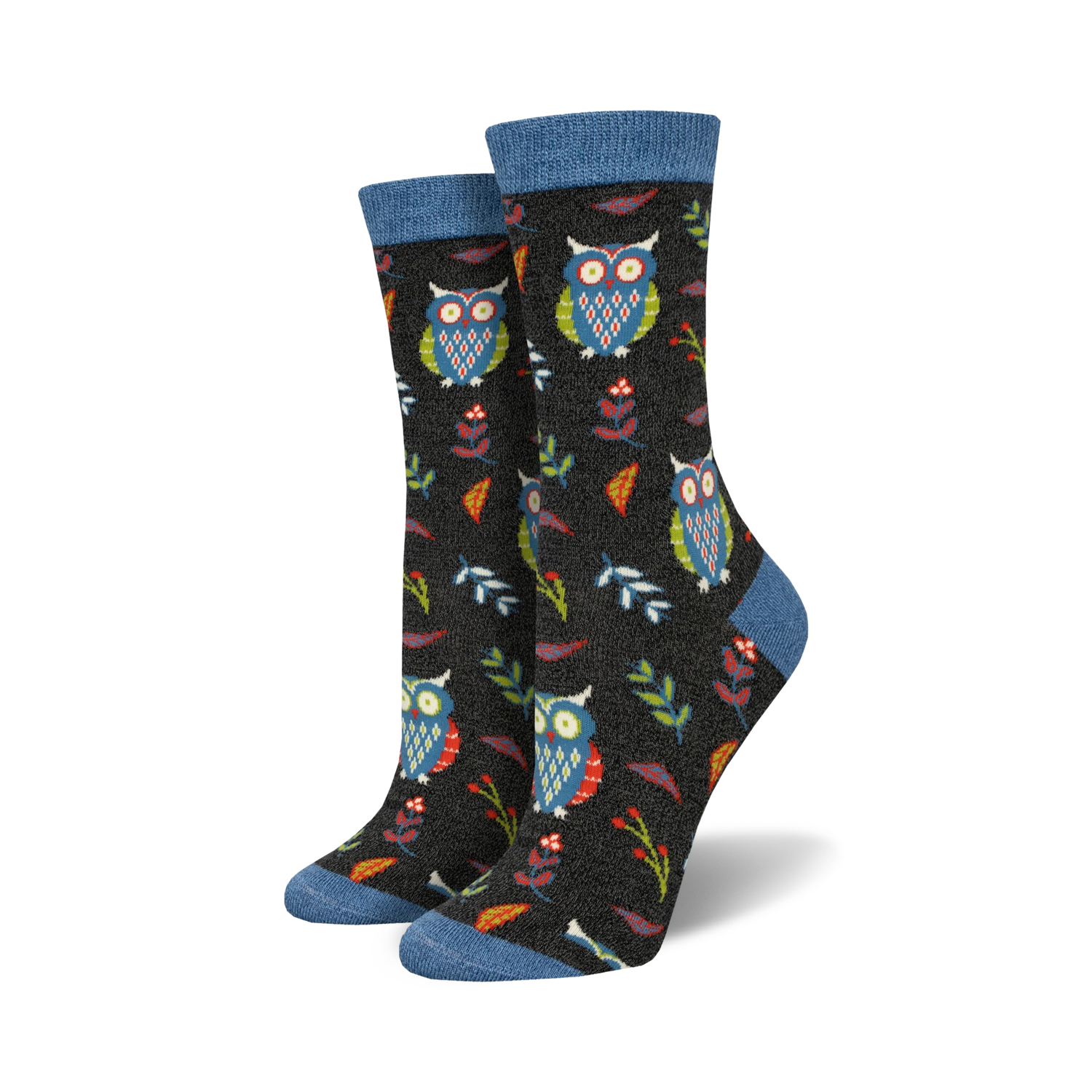 Close-up of a pair of black crew socks with owls, leaves, and berries. Blue top trim.