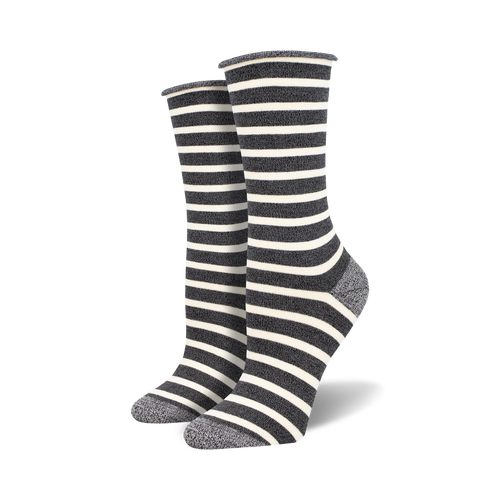Two dark grey and white striped socks with light grey heels and toes on foot mannequins.