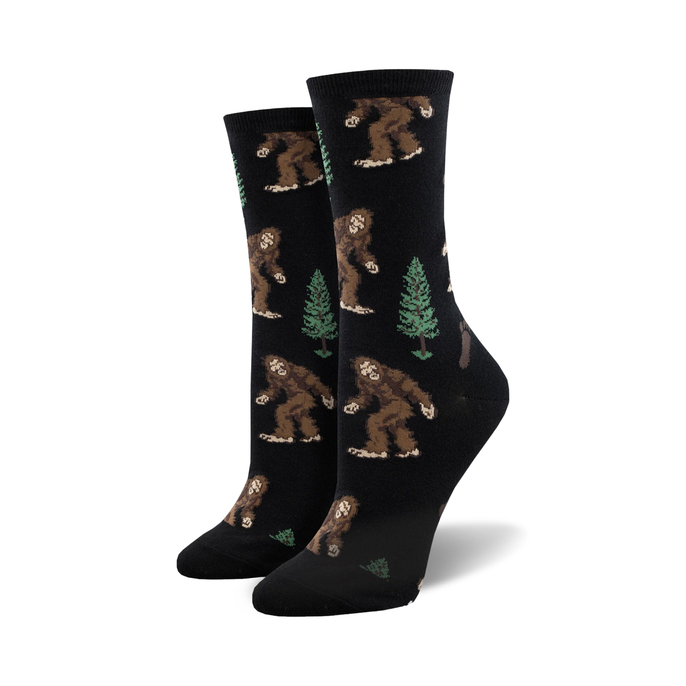 Pair of women's crew socks. Black background with repeating pattern of brown Bigfoot figures and green evergreen trees.