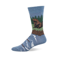 Light blue crew sock with a brown beaver sitting on green land, a brown log dam, green pine trees, and blue water with floating logs.