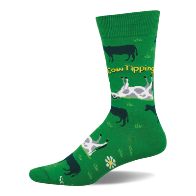 Green crew sock with a "Cow Tipping" design. Features dark silhouette cows, white and grey spotted upside-down cows, yellow text, and white flowers.