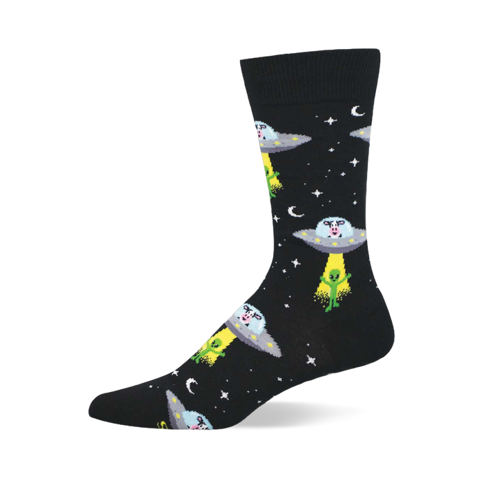 Black crew socks with a repeating pattern of grey UFOs abducting green aliens, with cow heads visible inside the saucers. }}