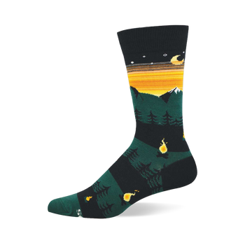 Single crew sock showing dark green mountains, snow caps, orange and yellow striped sky, moon, stars, pine trees, and campfires.